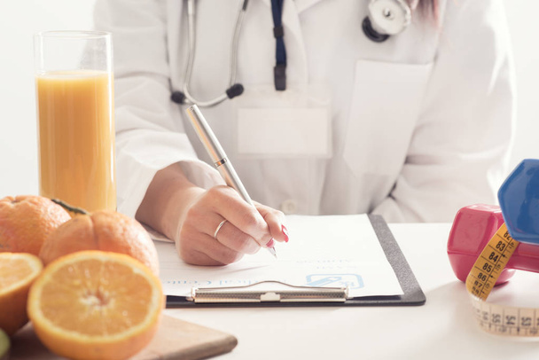 Female Dietician With Fresh fruits and diary - Photo, Image