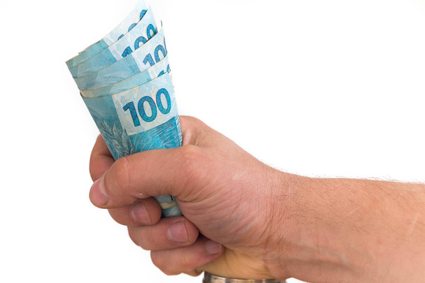 Gran cantidad de dinero brasileño, reales, en la mano, concepto de éxito
 - Foto, Imagen