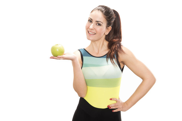 Retrato de feliz sonrisa joven hermosa mujer en ropa de fitness con manzana
 - Foto, Imagen