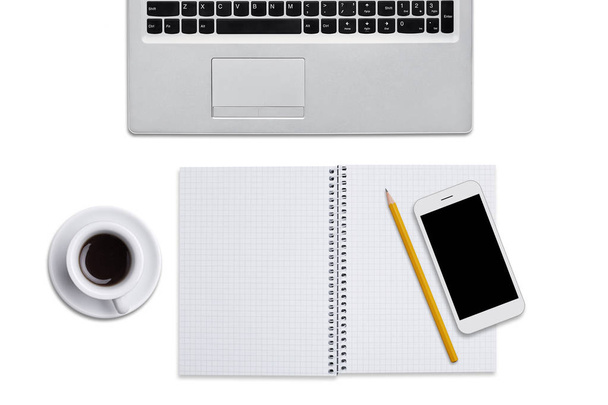 Top view of laptop, spiral notebook with pencil, smart phone and cup of coffee isolated over white background. Work place of businessman. Desktop with modern devices and notepad for writing notes - Photo, image