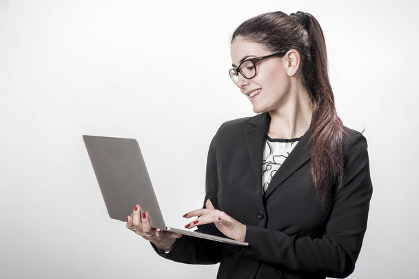 Young successful career woman holds her laptop  - Fotó, kép
