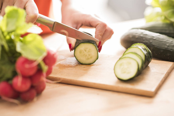 Chef is cutting cucumber  - Foto, immagini