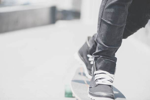 Close up of skater's legs on the longboard riding at the street in outdoors - Foto, Imagem