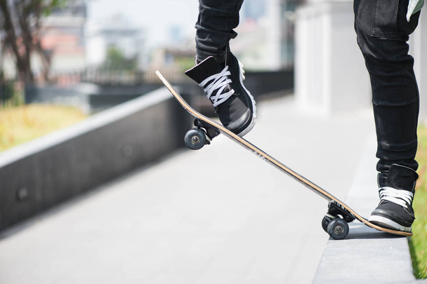 Boy skater is doing stunt at the street - Fotografie, Obrázek