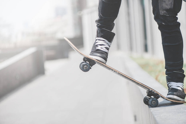 Boy skater is doing stunt at the street - 写真・画像