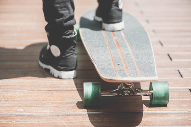 Close up of skater's legs on the longboard riding at the street in outdoors - Foto, immagini