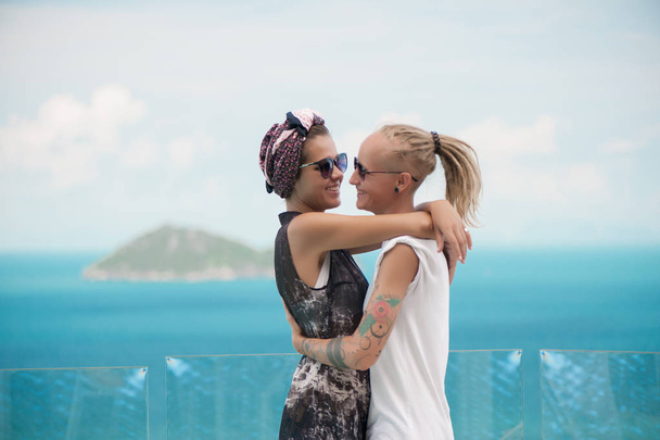 Happy couple in sunglasses hugging and kissing - 写真・画像