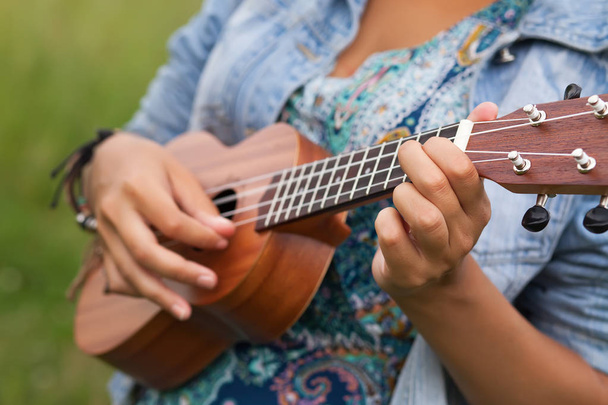 Young hipster woman playing on Ukulele outdoors - Fotografie, Obrázek