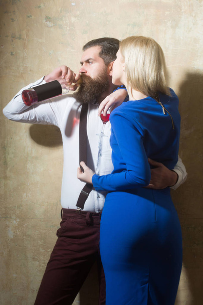 Man drinking wine from bottle and hugging girl with glass - Φωτογραφία, εικόνα