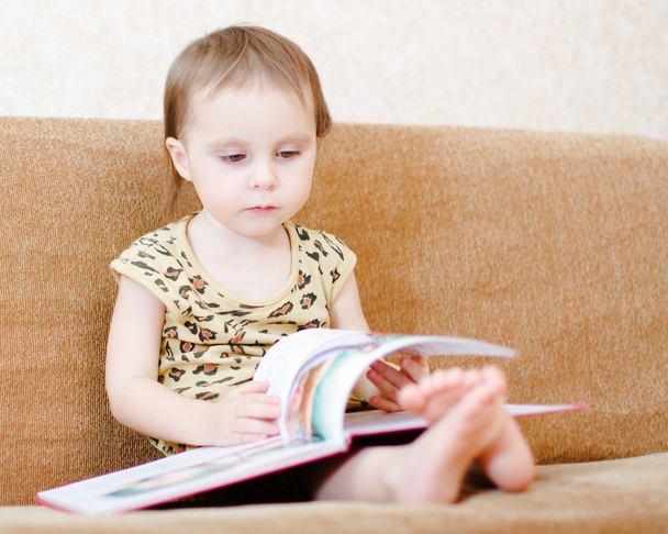 Beautiful cute baby reading a book - Zdjęcie, obraz