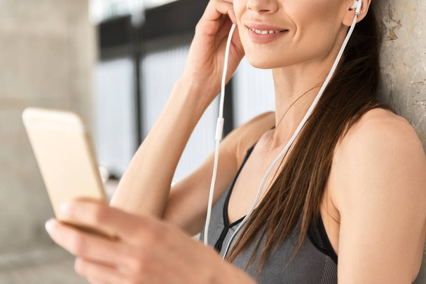 Happy young girl listening to favorite song after workout - Fotoğraf, Görsel