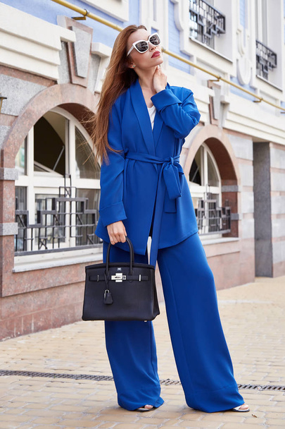 Beautiful sexy blond woman swear elegant blue suit for businessw - 写真・画像
