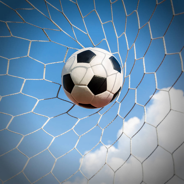 Soccer football in Goal net with the sky field. - Fotó, kép