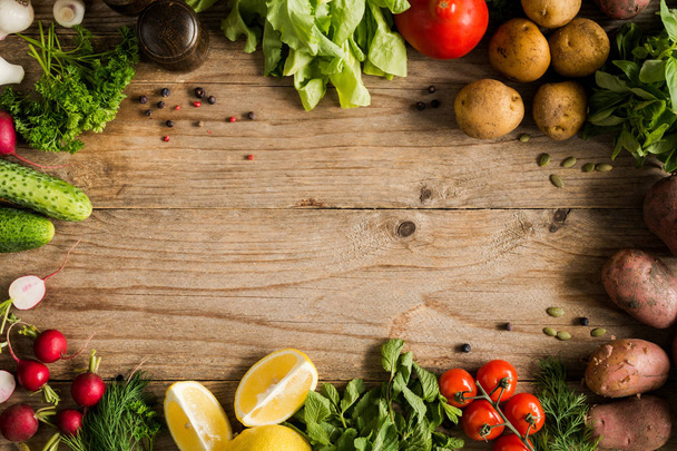 Vegetables, greens and spices on wooden background - Φωτογραφία, εικόνα