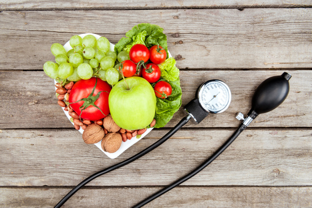 vegetables, fruits and blood pressure gauge - Foto, imagen