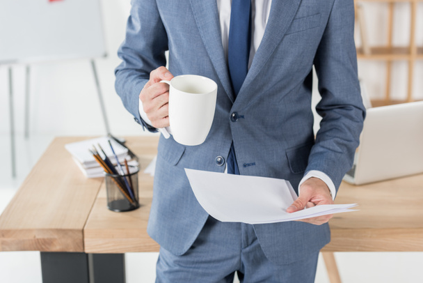 businessman with coffee cup and papers - Photo, Image