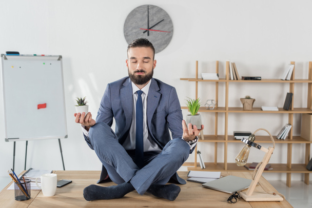 businessman sitting in lotus position - Photo, Image