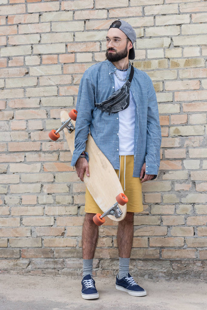 stylish man with longboard - Фото, изображение