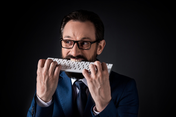 businessman biting keyboard - Fotografie, Obrázek