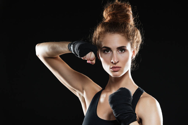 Close-up portrait of Concentrated female fighter ready to fight - 写真・画像