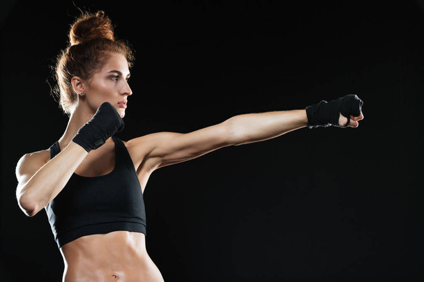 Side view of Calm female fighter practicing - Fotografie, Obrázek