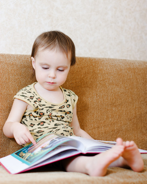 Beautiful cute baby reading a book - 写真・画像