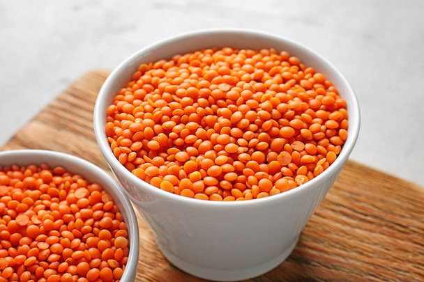 Bowls of red lentils on board - Foto, Bild