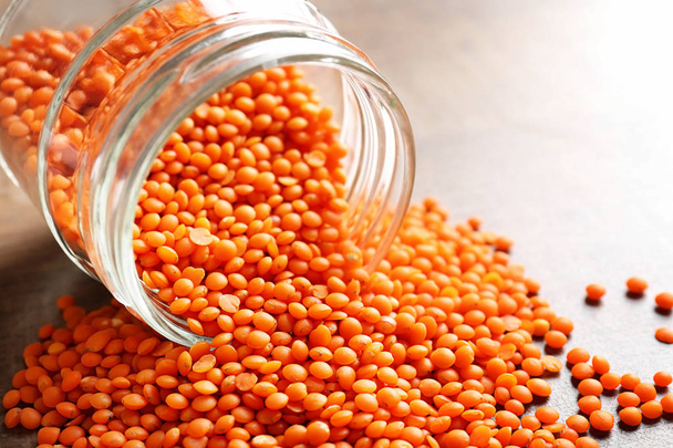 Jar of red lentils on table - Valokuva, kuva