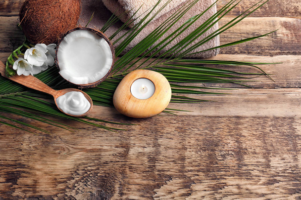 Composition with coconut cream in spoon for spa treatment on wooden background - Фото, зображення