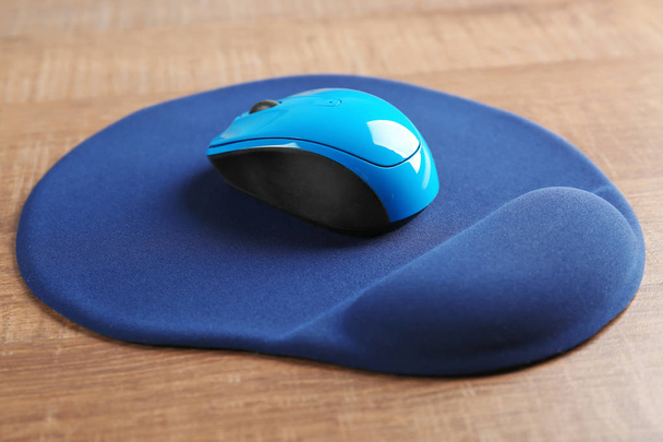Blank mat and wireless mouse on wooden background - Fotografie, Obrázek