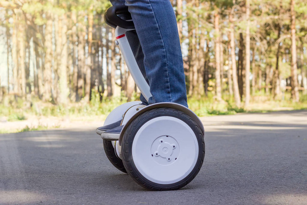 Legs of young man riding the self-balancing scooter  - Φωτογραφία, εικόνα