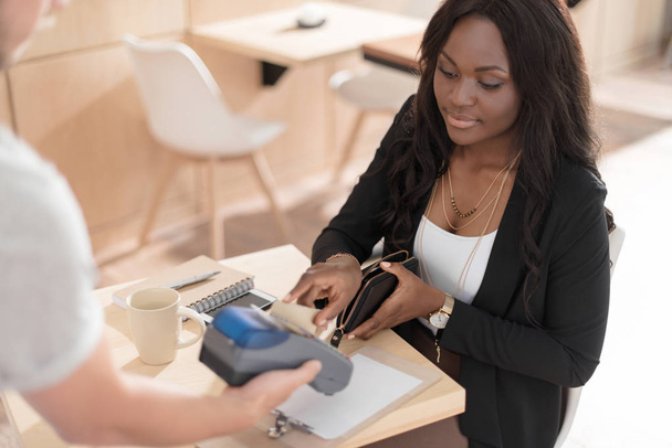 woman paying with credit in cafe  - Photo, Image
