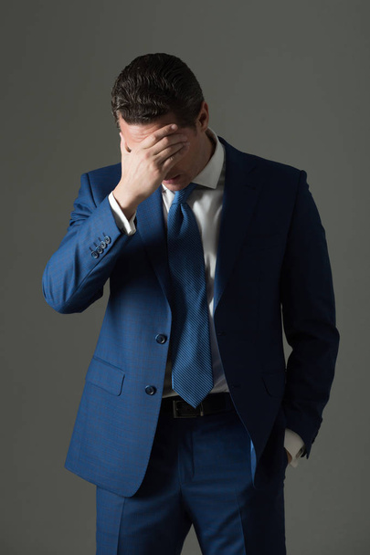 Tired man feeling headache with stylish hair in fashionable suit - Фото, зображення