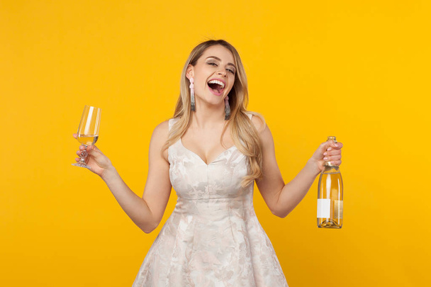 Happy girl laughing holding wine bottle - Fotografie, Obrázek