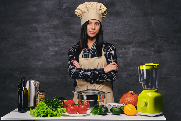 Studio portrait of chef with vegetables - Photo, Image