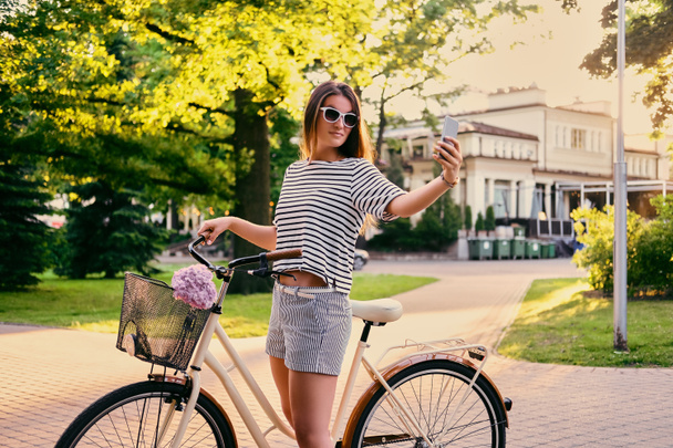 自転車で公園でブルネットの女性 - 写真・画像