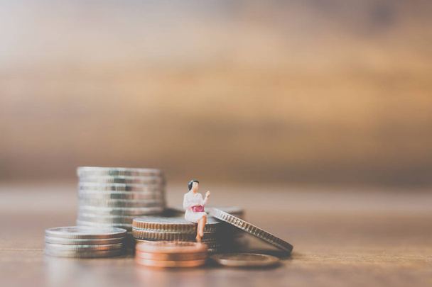 Miniature people businessman  on coins  - Photo, Image