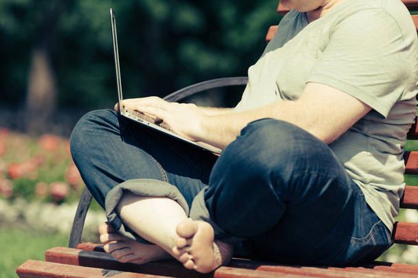 Man sitting on a Bench with notebook - Fotó, kép