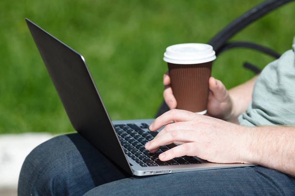 Man with laptop in park on a sunny day - Foto, Imagem