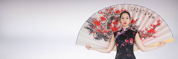Geisha with giant fan against white background - Foto, Imagen