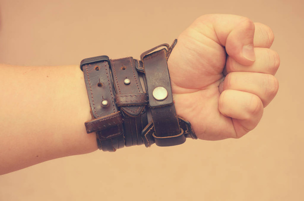 Modern fashionable leather and metal bracelets on the wrist. - Foto, imagen