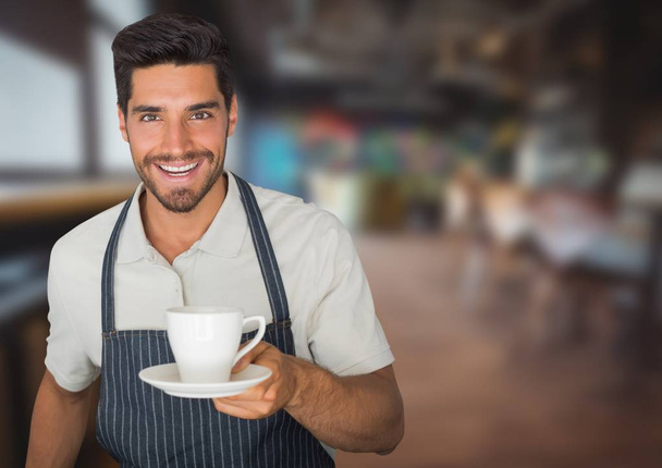 Cafe owner  handing out cup of coffee against blurry cafe - Photo, image