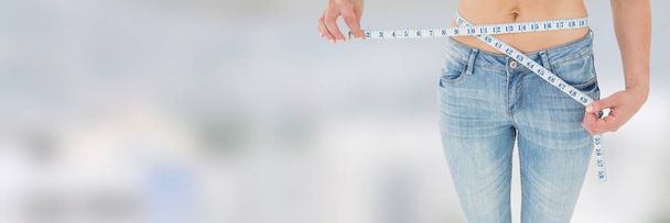 Slim healthy woman holding measuring tape - Фото, зображення