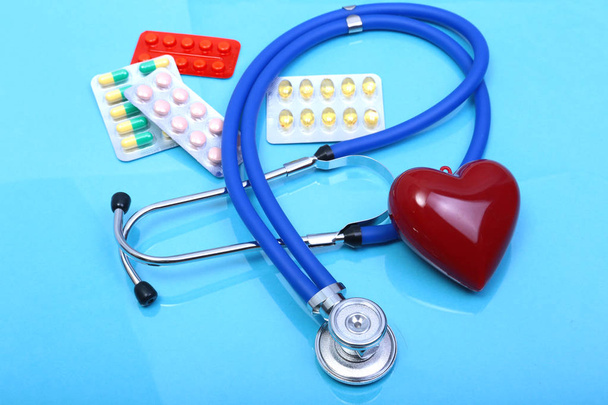 RX prescription, Red heart, asorted pils and a stethoscope on white background - Фото, изображение