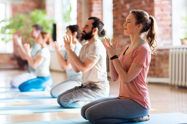 group of people meditating at yoga studio - Fotografie, Obrázek
