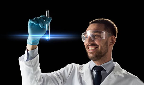 smiling scientist in goggles with test tube - Foto, immagini
