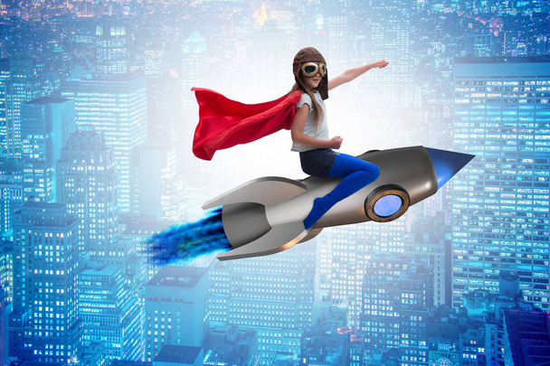 Little girl flying rocket in superhero concept - Photo, Image