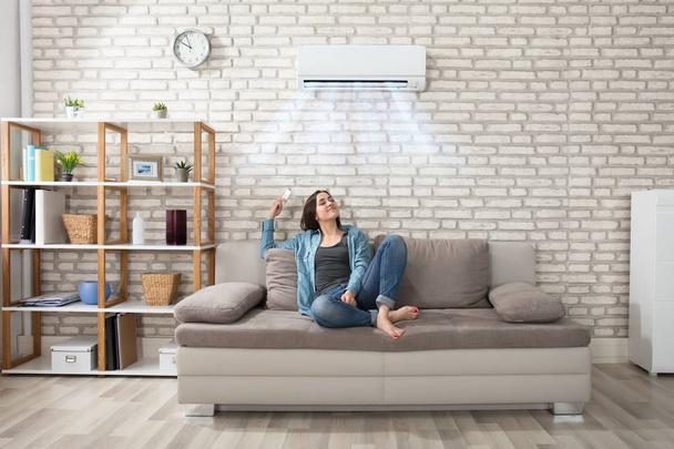 Woman Relaxing Under Air Conditioner - Photo, Image