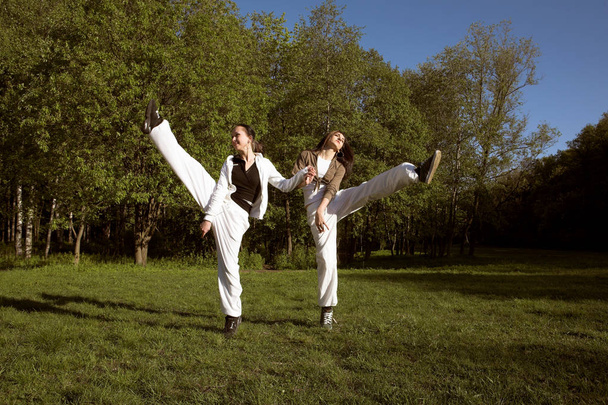 two girl jumping in park - Valokuva, kuva