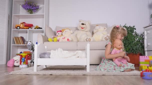 Baby girl playing with doll - Felvétel, videó